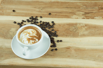 Cappuccino and latte art on the wood table. Free hand pouring some milk on the coffee. Morning breakfast with coffee.