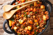 Picadillo Recipe Ground beef, carrot and potatoes cooked in a tomato sauce closeup on a pan. horizontal top view