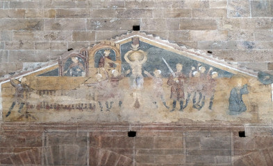 Fresco featuring the Martyrdom of Saints Lawrence, Vincent and Stephen in Basilica of Saint Frediano, Lucca, Tuscany, Italy 