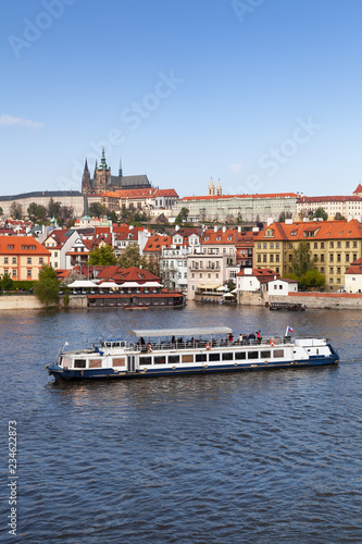 Fotografie, Obraz Small passenger ship goes on Vltava river
