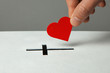 © adragan - Donation of your heart as symbol of love for the religion of Christianity. Box for donations with slot in the form of Christian christe. Man puts hand donations.