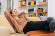 Woman is resting on a couch and smiling
