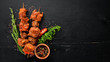 Skewers of barbecue sauce. On a wooden background. Top view. Free space for your text.