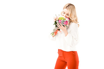 Beautiful young woman smelling bunch of flowers isolated on white