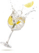 lemon slice falling into a splashing gin tonic 