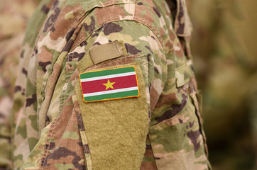 Flag of the Suriname on soldiers arm (collage).