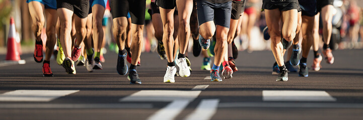 Marathon runners running on city road, large group of runners