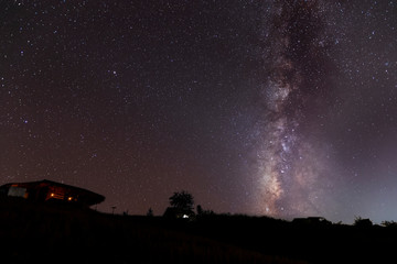 Wall Mural - Milky Way Galaxy over hut on paddy rice field  at night sky.