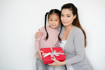 Wall Mural - Asian mom delivers red gift box to daughter On the birthday is to deliver love, caring, which is the basis of the family. Celebrated during the Christmas season. And happy new year. Annual discount