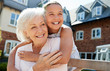 © Monkey Business - Granddaughter Hugging Grandmother On Bench During Visit To Retirement Home