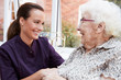 © Monkey Business - Female Resident Sitting In Chair And Talking With Carer In Retirement Home