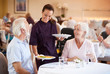 © Monkey Business - Senior Couple Being Served With Meal By Carer In Dining Room Of Retirement Home