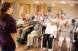 © Monkey Business - Carer Leading Group Of Seniors In Fitness Class In Retirement Home