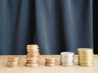 stacks of coins and stock chart