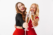 Happy Young Two Girls Friends Posing Isolated Over White Wall Dressed In Black And Red Clothes.