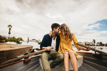 Wall Mural - Romantic couple on a boat date in a lake