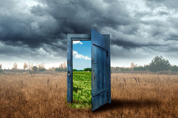 creative background. old wooden door, blue color, in the box. transition to a different climate. the