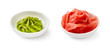 Wasabi and pickled ginger in bowls isolated on white background.