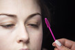 © strigana - Eye lash extension procedure. Young beautiful woman eye with long false eye lashes. Close up macro shot of master making eyelashes in beauty salon.
