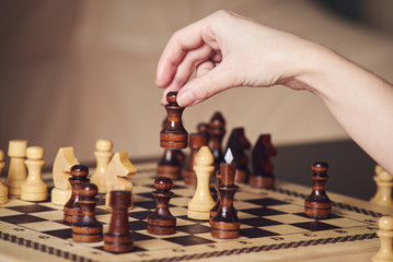 The hand is making move. turn, while playing chess match.