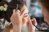 Fototapeta Na ścianę - young woman applying makeup, eyebrows and eyelashes
