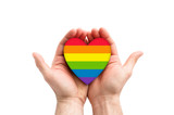 Fototapeta Tęcza - LGBT rainbow heart symbol of love in hands