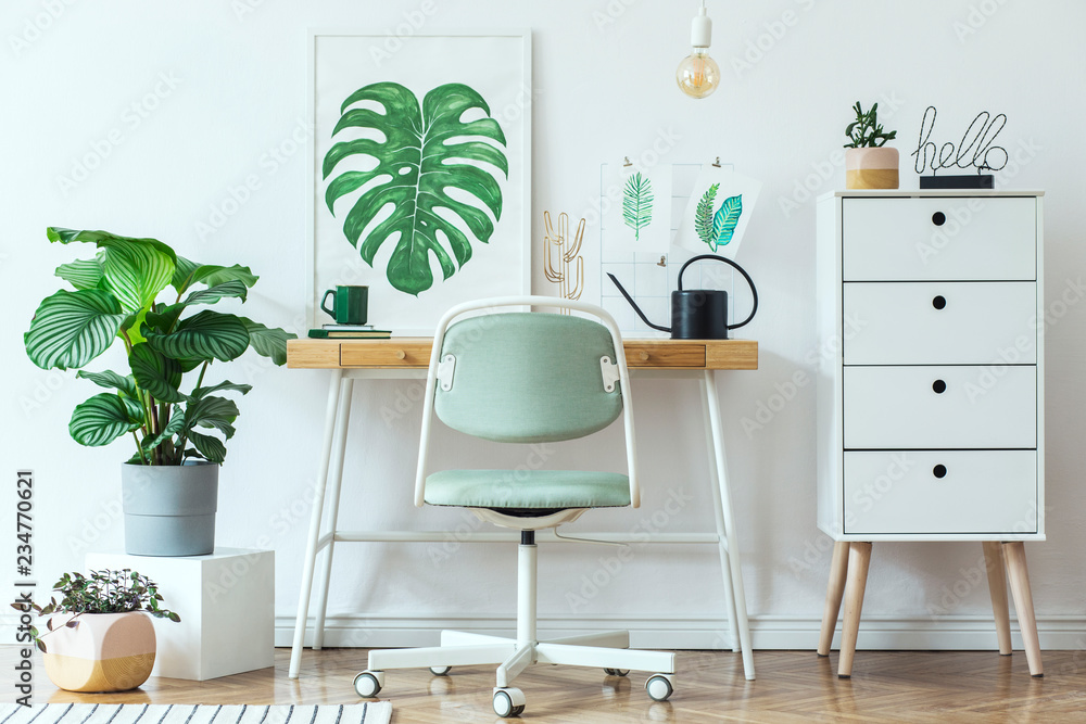 Stylish scandinavian home office desk with mock up poster frames, a lot of plants and office accessories. Brown wooden parquet and white backgrounds wall. Modern composition of homeoffice desk. - obrazy, fototapety, plakaty 