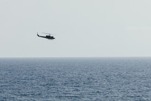 Helicopter Flying Over Blue Sea