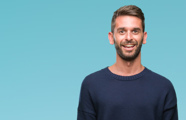 Young handsome man wearing winter sweater over isolated background with a happy and cool smile on face. Lucky person.