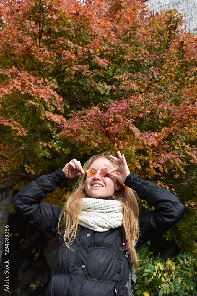 Portrait of beautiful smiling long hair blond girl with coloured dried ...