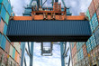 © ake1150 - Industrial crane loading Containers in a Cargo freight ship. Container ship in import and export business logistic company. Industry and Transportation concept.