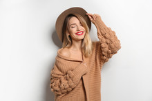 Beautiful Young Woman In Warm Sweater With Hat On White Background
