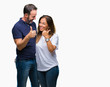 © Krakenimages.com - Middle age hispanic casual couple over isolated background doing happy thumbs up gesture with hand. Approving expression looking at the camera with showing success.