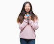 © Krakenimages.com - Young asian woman drinking coffee over isolated background with a happy face standing and smiling with a confident smile showing teeth