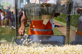 Fototapeta Dmuchawce - Making popcorn with machine