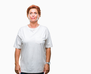 Canvas Print - Atrractive senior caucasian redhead woman over isolated background with serious expression on face. Simple and natural looking at the camera.