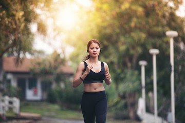 Running woman. Female runner jogging during outdoor  on road .Young mixed race girl jogging