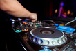 © Семен Саливанчук - DJ turntable console mixer controlling with two hand in concert nightclub stage.