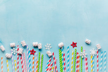 Drinking Paper Colorful Straws For New Year Cocktails On Light Blue Background. Christmas Card. Top View.