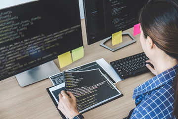 Professional programmer working at developing programming and website working in a software develop company office, writing codes and typing data code