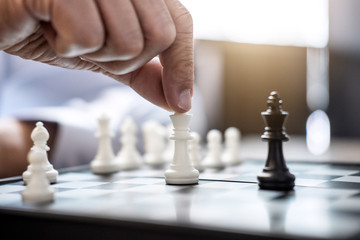 Wall Mural - Hands of confident businessman colleagues playing chess game to development analysis new strategy plan, leader and teamwork concept for win and success