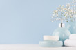 Fresh spring decor for bathroom with small white flowers, ceramic vase and soap pump bottle, towel on white wood board.