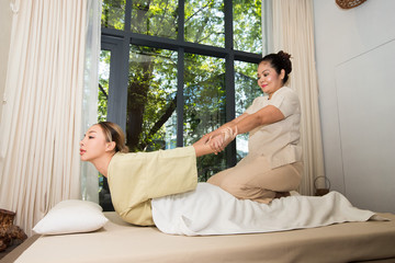 Wall Mural - Masseuse stretching bending massage shoulder back