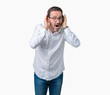 © Krakenimages.com - Handsome middle age elegant senior business man wearing glasses over isolated background Trying to hear both hands on ear gesture, curious for gossip. Hearing problem, deaf