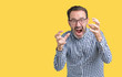 © Krakenimages.com - Handsome middle age elegant senior man wearing glasses over isolated background Shouting frustrated with rage, hands trying to strangle, yelling mad