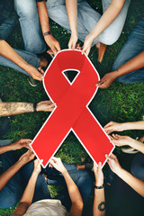 Wall Mural - Group of people holding a red colored ribbon