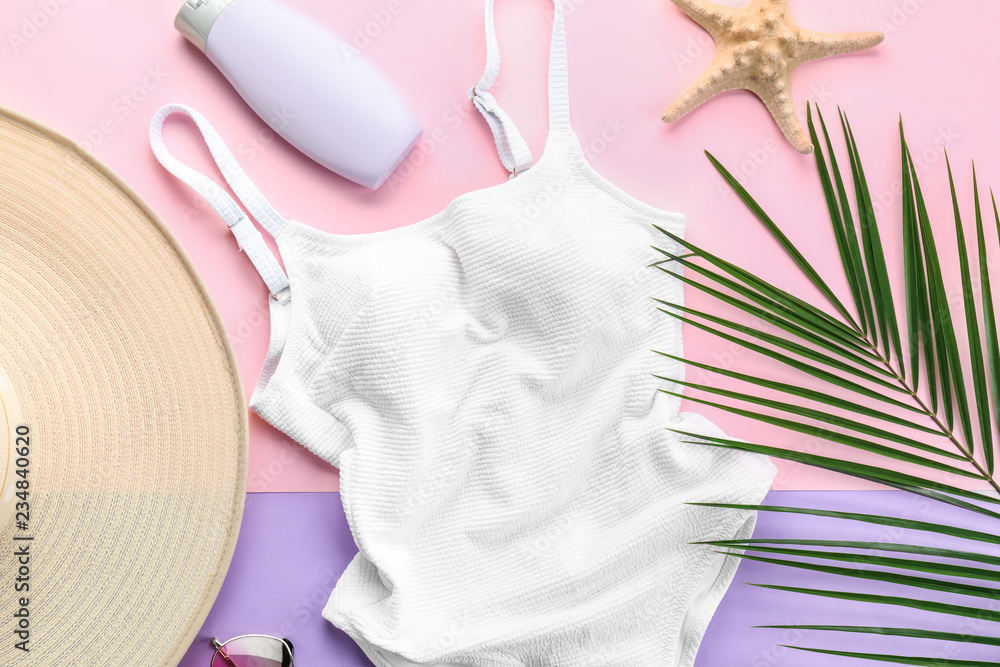 Composition with swimsuit and beach items on color background