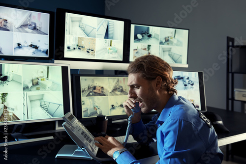 Security Guard Monitoring Modern Cctv Cameras In