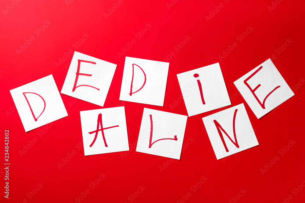 Word DEADLINE made of paper sheets on color background