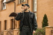 © Pixel-Shot - Male security guard with portable radio transmitter outdoors